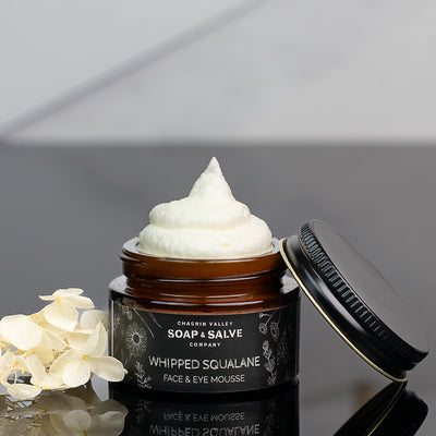 organic squalane face and eye cream near flowers and lid